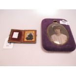 An early Victorian photograph of a young girl, in tooled leather folding frame, together with an