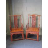 A pair of modern Chinese hardwood elbow chairs, a side table and a similar glazed display cabinet (