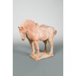 A pottery figure of a horse, possibly Tang dynasty, well-modelled, the animal standing foursquare on