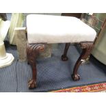 A mahogany stool, suede covered seat, on claw and ball feet height55cm width 48 cm depth 46