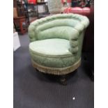 A pair of Victorian tub armchairs, upholstered in a green damask, on turned legs and casters (2)