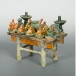 A Ming dynasty sancai glazed offering table, the table covered in green, amber and yellow glaze, and