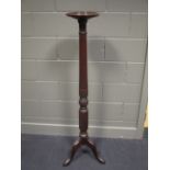 A mahogany torchere