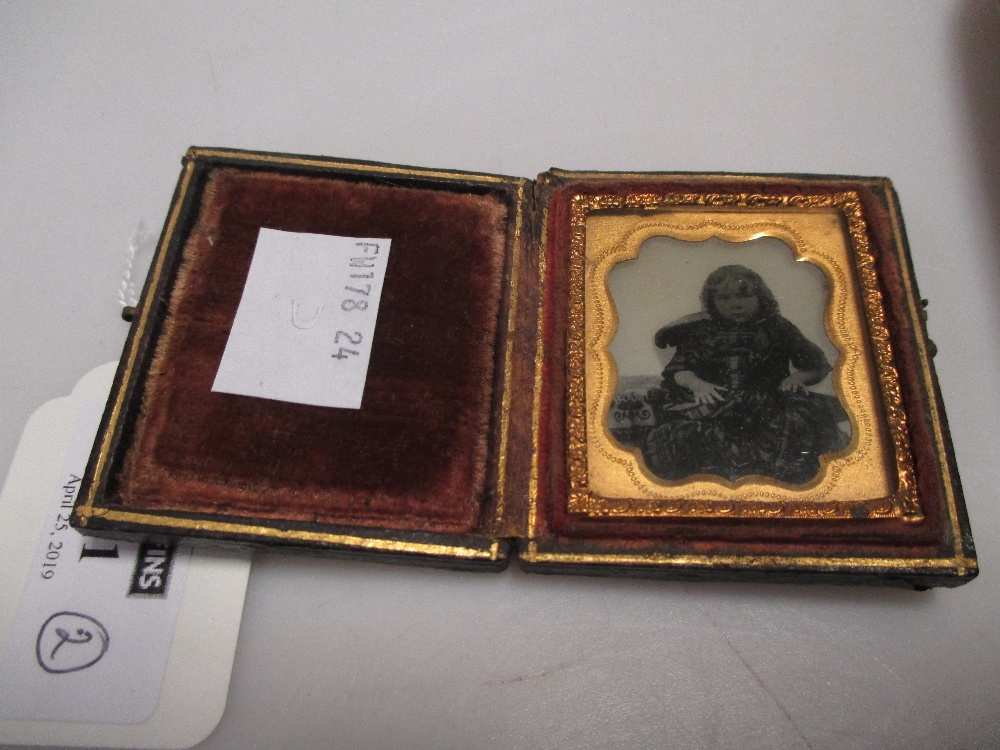 An early Victorian photograph of a young girl, in tooled leather folding frame, together with an - Image 2 of 3