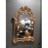 A George III style gilt framed wall mirror H115cm 77cm wide