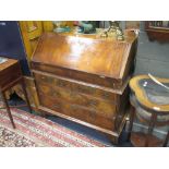 A George I walnut bureau, with two short and two long graduated drawers, on shaped bracket feet (