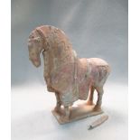 A pottery model horse, Sui or early Tang dynasty, the head slightly lowered, on a rectangular base
