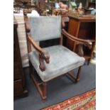 A late 19th century walnut elbow chair with carved terminals