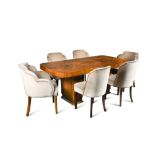An Art Deco walnut dining table and six chairs, the twin pedestal table with rounded rectangular top