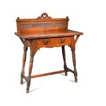 An Arts and Crafts walnut side table, the rectangular top with pierced and carved gallery back, a