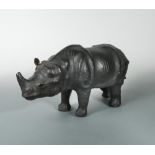 A leather clad model of a rhino, modelled standing 26 x 54cm (10 x 21in)