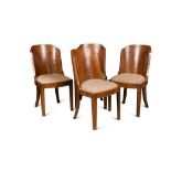 A set of four Art Deco walnut dining chairs, the shaped solid backs above drop-in seats raised on