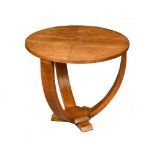 An Art Deco period pale oak occasional table, the circular top raised on three legs which curve to