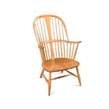 An Ercol comb-back double bow 'Chairmakers' Windsor armchair, with shaped seat, label to reverse