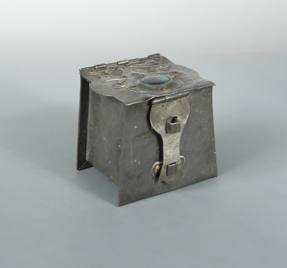 An Arts & Crafts pewter box or tea caddy with enamel cabochon, the repoussé box with applied strap