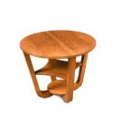 An Art Deco walnut occasional table, the circular top on four inswept supports with shaped undertier