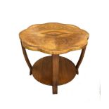 An Art Deco walnut occasional table, the quarter veneered shaped top on four inswept legs united