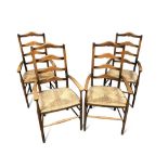 A set of four Arts & Crafts ladder back armchairs, each with shaped back rails to rush seats and