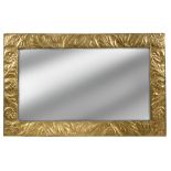 An Arts & Crafts brass wall mirror, the rectangular frame embossed with foliate motifs 81 x 127cm (