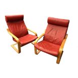 A pair of formed laminate bentwood cantilever lounge chairs, with red leather cushions (2) 97 x 68cm