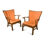 Fritz Hansen, a pair of stained beech lounge chairs, each with loose orange fabric cushions, branded