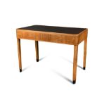 An Art Deco satin wood writing or library table, the rounded rectangular leather inset top with