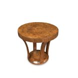 An Art Deco walnut occasional table, the circular top on four in-turned supports and chamfered