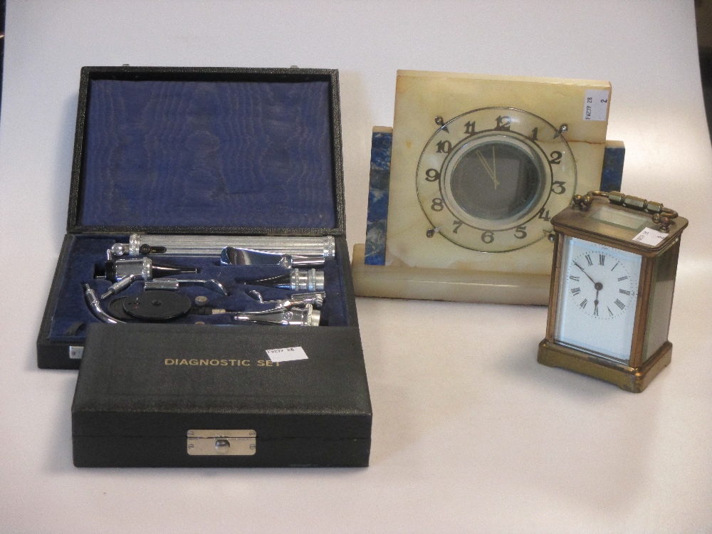 An onyx mantel clock, carriage timepiece and two opthalmoscopes (one incomplete) (4)