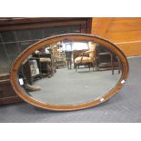 An oval mahogany mirror, 78 x 53cm