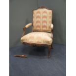 A Louis XIV carved walnut fauteuil, with pink watered silk upholstery (one leg broken; worm damage)