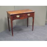 A George III provincial mahogany and oak side table, with twin flower head embossed oval brass