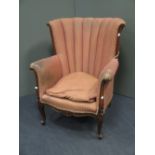 A fan backed mahogany wing armchair, on cabriole legs (old damage)
