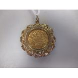A 9ct gold cast pendant mount containing a George V half sovereign dated 1913 8.7g gross