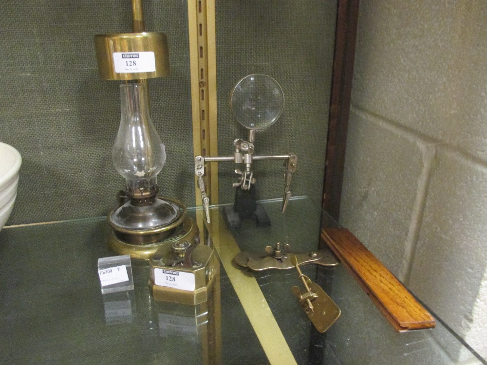 A 19th century brass scarificator, a Swift microscope lamp, a magnifier and two brass early style