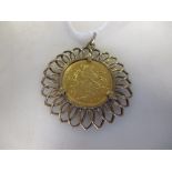 A 9ct gold pendant containing an Edward Vll half sovereign dated 1902, 7.8g gross