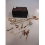A small laquer box containing two pairs of 9ct gold earpendants a pair of small hoop earrings and