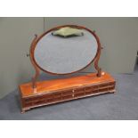 An Edwardian mahogany and inlaid dressing table mirror fitted six small drawers, on ogee bracket