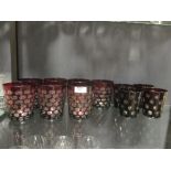 Eleven bohemian ruby red water glasses togther with a large quantity of other glasses