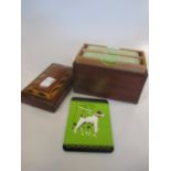 A wooden card box with Fox Terrier playing cards inside