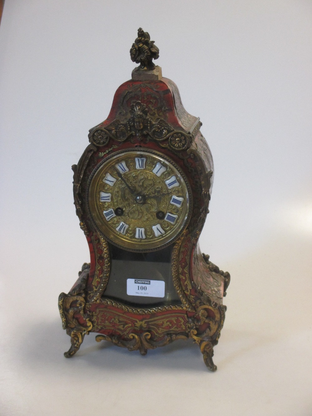 A French Boulle case mantel clock, brass inlaid, later finial, few cracks and losses to the inlay