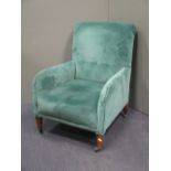 An Edwardian tub armchair, reupholstered, on short square feet and castors