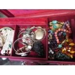 A travelling jewellery box containing a collection of mainly hardstone bead necklaces and silver