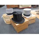Three top hats in boxes