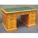 A pale wood twin pedestal desk, with official stamp and dated '1937', and an oak Arts and Crafts