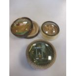 Three circular 19th century pill or keepsake boxes with glass covers, two with floral emblems, the