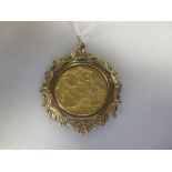 A 9ct gold cast pendant mount containing a George V sovereign dated 1915, 11.6g gross