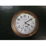 A brass case car dash-board clock, the 6cm dial marked for Selfridge & Co Motor Depart[ment], 9.