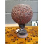 A carved coconut shell on stand
