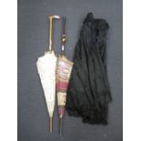 A black Victorian cape, an Edwardian lace shawl and two parasols (4)
