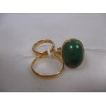 A 22ct gold and moss agate ring and two 22ct wedding bands